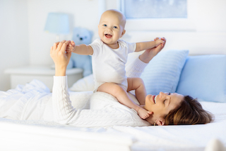 bigstock mother and baby on a white bed 257985100