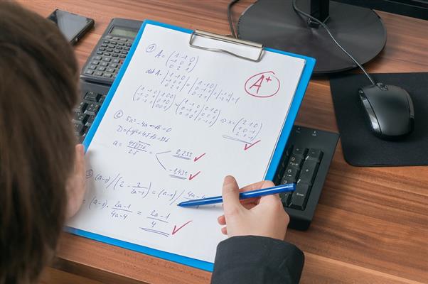 bigstock teacher is correcting and grad 138490547