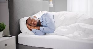 bigstock man sleeping in bed person dr 476876251